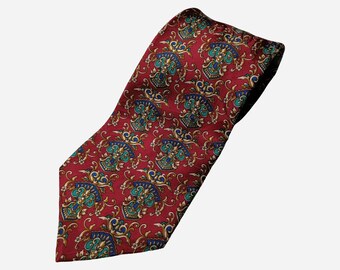 May include: A red silk tie with a paisley pattern in gold, blue, and green.