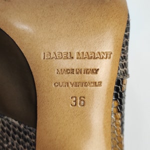 May include: Close-up of the sole of a brown leather shoe with a snakeskin pattern. The shoe is labeled "Isabel Marant" and "Made in Italy." The size is 36.