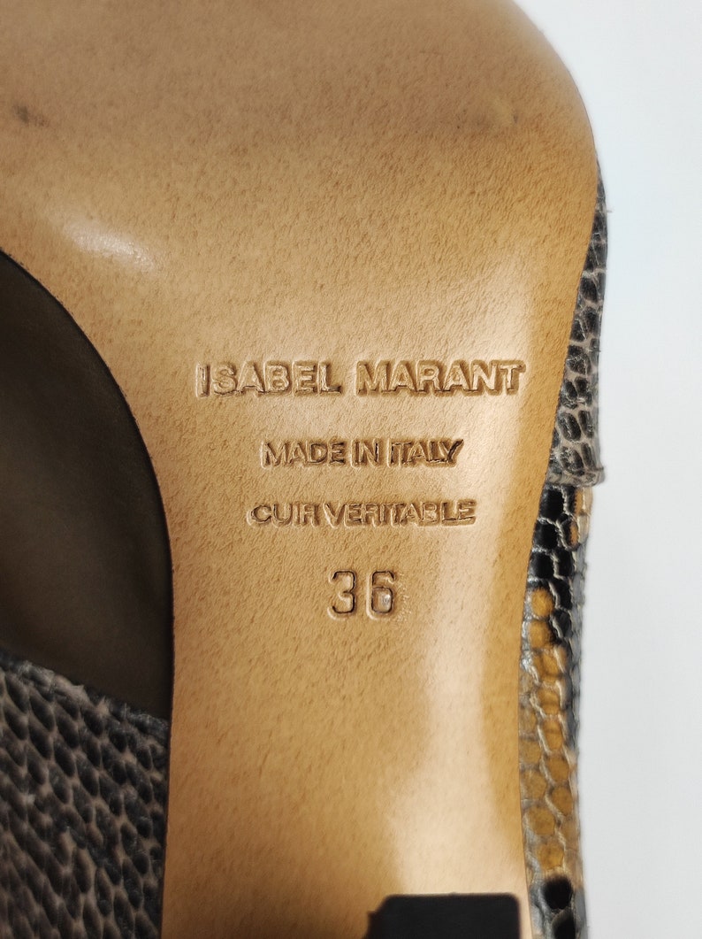 May include: Close-up of the sole of a brown leather shoe with a snakeskin pattern. The shoe is labeled "Isabel Marant" and "Made in Italy." The size is 36.