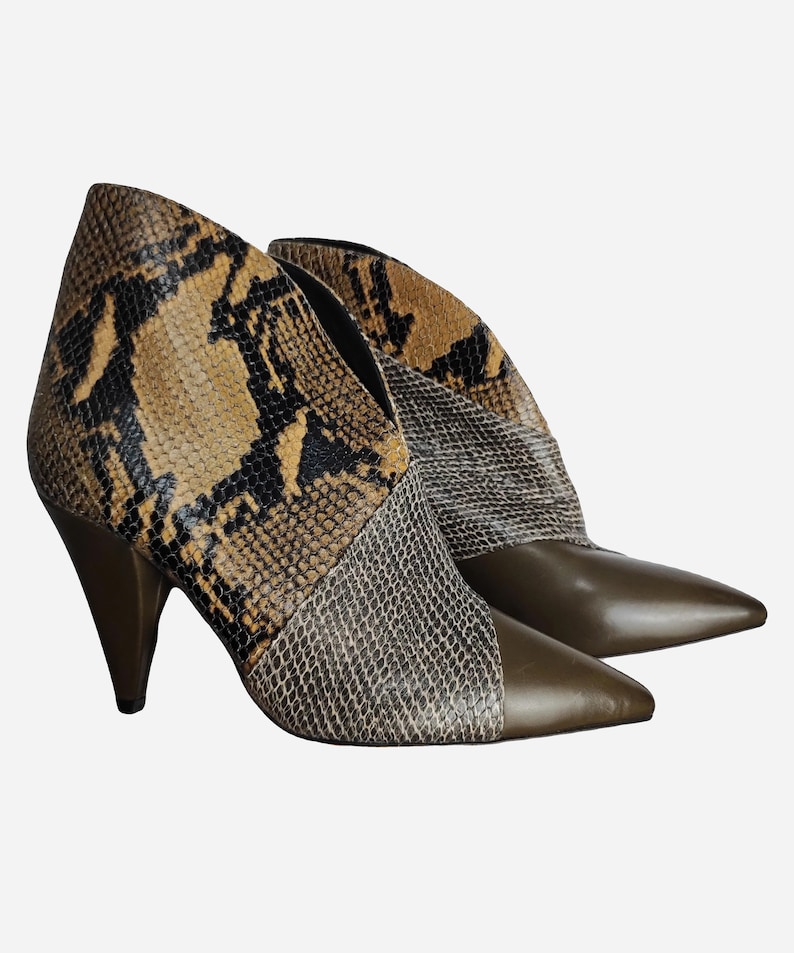 May include: Brown and tan snakeskin ankle boots with a pointed toe and a high heel.