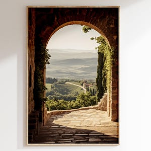 Tuscan arch print: brick Italian archway framing a countryside valley with stone path and olive trees in oil painting style.