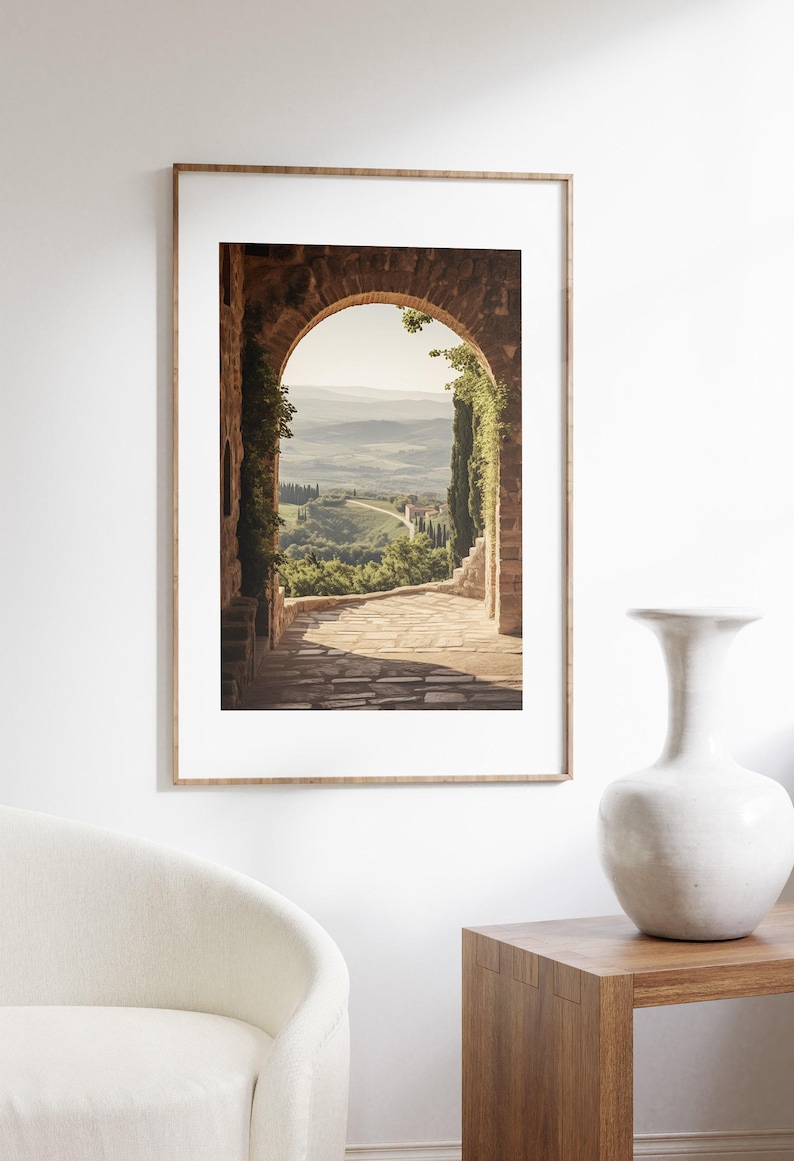 Tuscan arch print: brick Italian archway framing a countryside valley with stone path and olive trees in oil painting style.