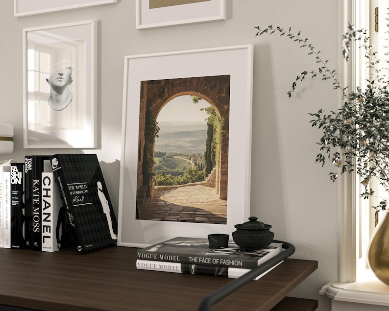 Tuscan arch print: brick Italian archway framing a countryside valley with stone path and olive trees in oil painting style.