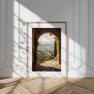 Tuscan arch print: brick Italian archway framing a countryside valley with stone path and olive trees in oil painting style.