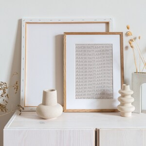 May include: A white wooden shelf with three ceramic vases. The vases are all different shapes and sizes. The shelf is decorated with dried flowers in a white ceramic vase.