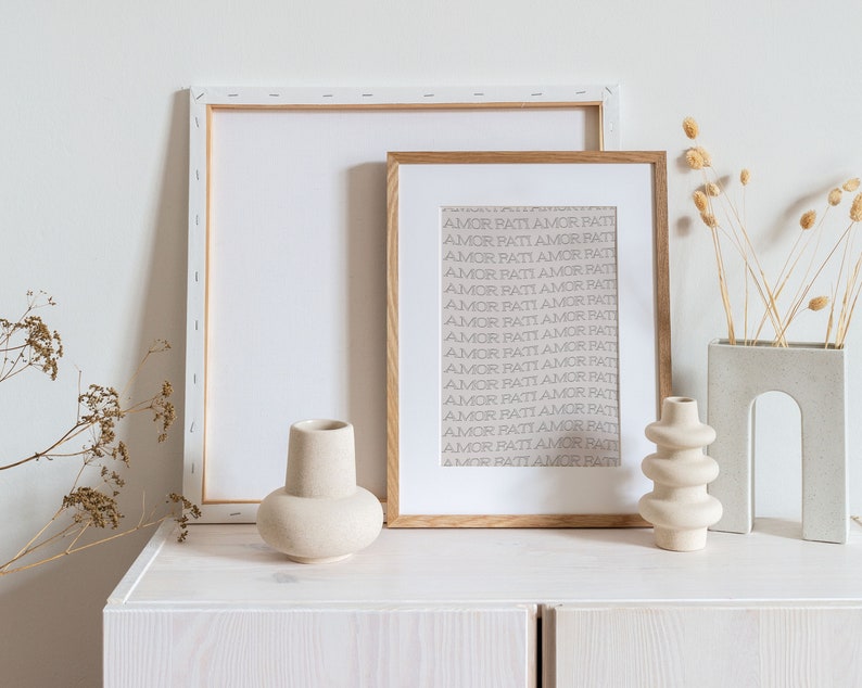 May include: A white wooden shelf with three ceramic vases. The vases are all different shapes and sizes. The shelf is decorated with dried flowers in a white ceramic vase.