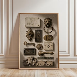 May include: A framed wall art print featuring a collection of architectural hardware and signage, including a Rue de Rivoli street sign, a lion head door knocker, a key, a Paris plaque, house numbers 12 and 8, and various ornate metal plates.