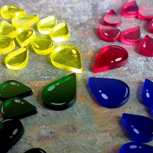 May include: Assortment of colorful teardrop-shaped acrylic tokens in yellow, red, blue, and green.