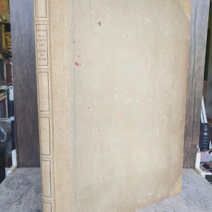 May include: A large, rectangular, tan-colored hardcover book with a textured fabric cover. The spine features a vertical label with the text "KETHAM FASCICULUS MEDICINAE" and the number "491" at the bottom, enclosed in thin, black-lined rectangular boxes.