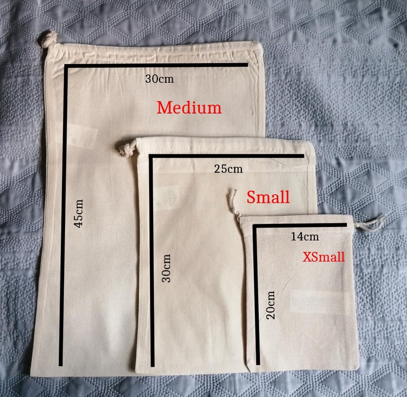 May include: Three cotton drawstring bags in different sizes. The largest bag is 30 inches by 45 inches and labeled "Medium". The middle bag is 25 inches by 30 inches and labeled "Small". The smallest bag is 14 inches by 20 inches and labeled "XSmall".