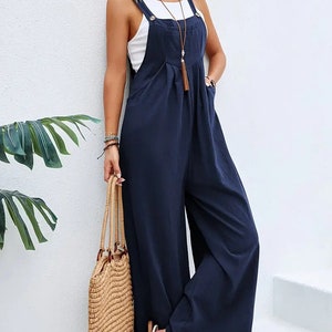 Long sleeveless overalls jumpsuit in Boho style, loose and casual, with pockets, women's clothing. Blue