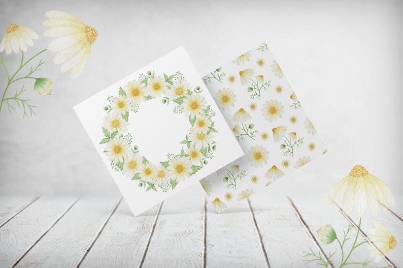 May include: Two white cards with watercolor illustrations of white daisies. One card features a wreath of daisies, the other card has a repeating pattern of daisies.