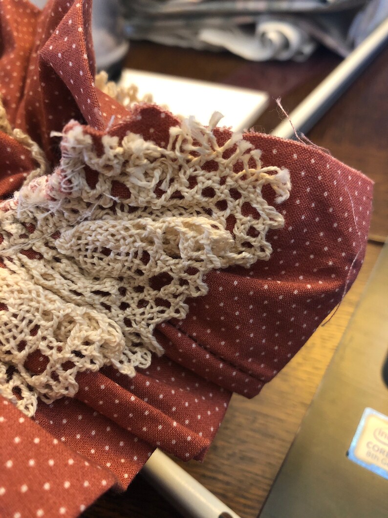 Rose polka dot ruffled trim with ecru crocheted lace