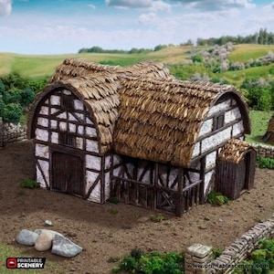 May include: A miniature model of a thatched-roof cottage with white-painted timber framing. The cottage has two doors and a small window. The model is made of brown and white painted cardboard and is set against a backdrop of green grass and a blue sky.