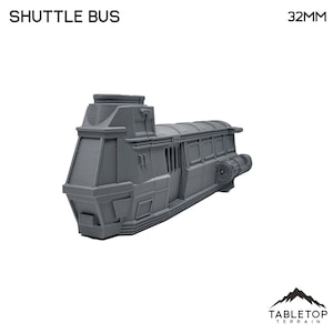 May include: A gray 3D printed model of a shuttle bus, approximately 32mm in length. The model has a rounded top and a detailed exterior with windows and a small engine.