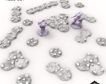 May include: A set of rough ground tiles for tabletop gaming. The set includes various shapes and sizes of terrain pieces, with a textured, rocky appearance. Two miniature robots are also included. The text "ROUGH GROUND TILES SET" is at the top.