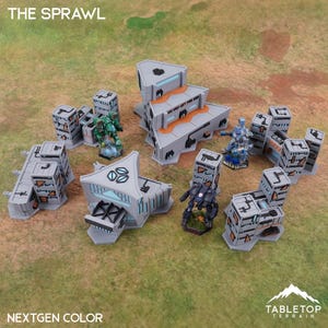 May include: A tabletop terrain set with the text "THE SPRAWL" and "NEXTGEN COLOR". The set includes gray futuristic buildings and miniature figures in green, blue, and black. The Tabletop Terrain logo is in the bottom right corner.