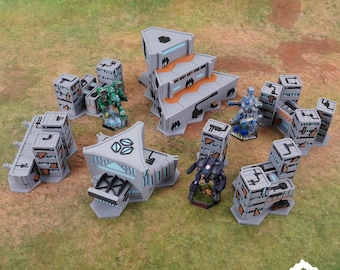 Puede incluir: Un conjunto de terreno de mesa con el texto "THE SPRAWL" y "NEXTGEN COLOR". El conjunto incluye edificios futuristas grises y figuras en miniatura verdes, azules y negras. El logotipo de Tabletop Terrain está en la esquina inferior derecha.
