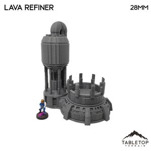 May include: A gray 28mm scale Lava Refiner model for tabletop gaming. The model includes a tall, cylindrical structure with a rounded top, connected to a circular base with a detailed design. A miniature figure stands nearby.