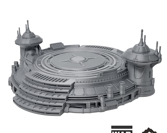 May include: A gray, detailed, 3D printed model of a circular landing pad with two towers. The landing pad has a central platform with concentric rings and a raised outer edge. The towers have a cylindrical base and a domed top with multiple antennas. The model is labeled "MASSA'DUN LANDING PAD" and "WAR SCENERY TABLETOP TERRAIN".