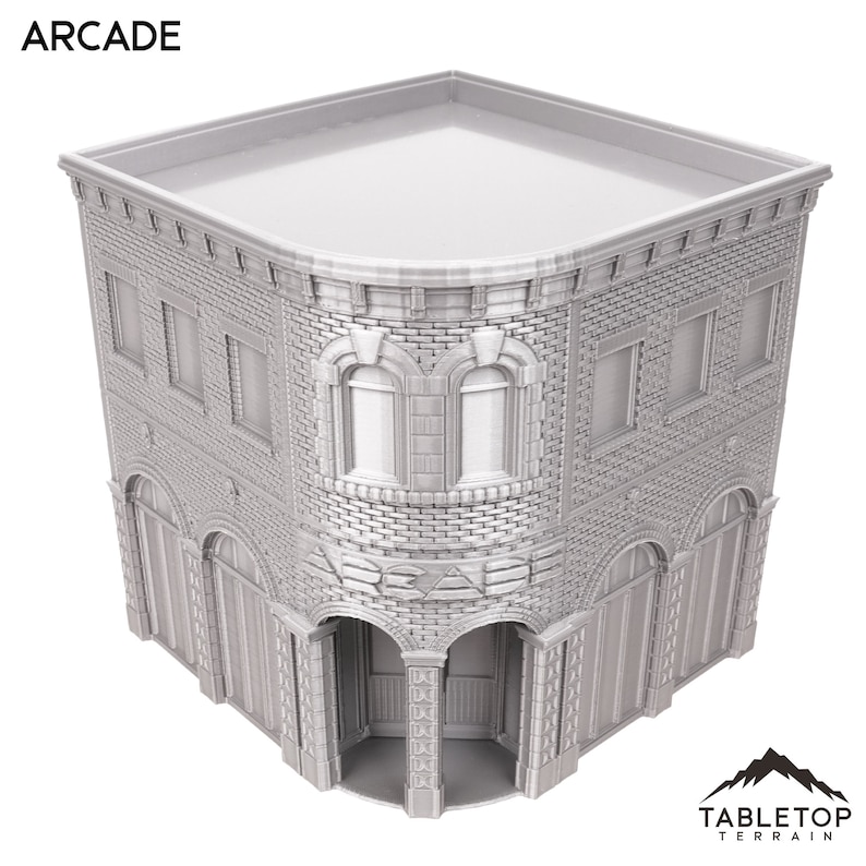 以下が含まれることがあります： 「ARCADE」と書かれた看板のある、灰色のレンガ造りの建物。建物は平らな屋根を持ち、両側に2つの窓とアーチ型の入り口があります。建物はミニチュアモデルです。