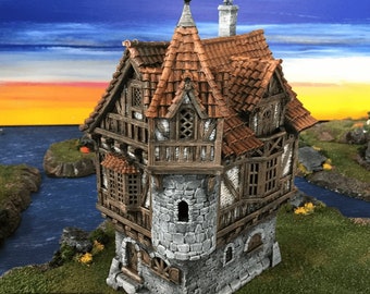 May include: A detailed model of a stone and wood tower house with a pointed roof, red tile roof, and multiple windows. The house is set against a backdrop of a blue sky with orange clouds.