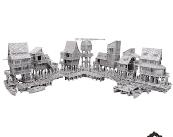 May include: A miniature model of a lakeside village with multiple buildings on stilts connected by wooden walkways. The buildings are made of grey plastic and have a medieval aesthetic. The model is labelled "Old Lake Village" and is a tabletop terrain piece.