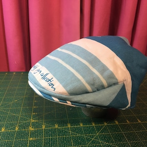May include: A blue and white striped newsboy cap with the text "My Collection" embroidered on the side.