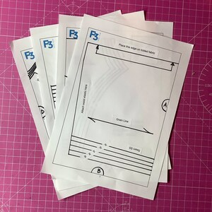 Puede incluir: Cuatro hojas de papel blancas con el texto "F3" impreso en ellas. La hoja superior tiene instrucciones para coser, incluyendo "Place this edge on folded fabric", "Grain Line", "Seam SS" y "Attach waist elastic here".
