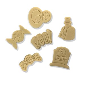 May include: A collection of tan-colored Halloween-themed cookie cutters. The shapes include a candy, a pair of eyes, the word "BOO!", a spider, a tombstone with "RIP", and a poison bottle with a skull and crossbones.