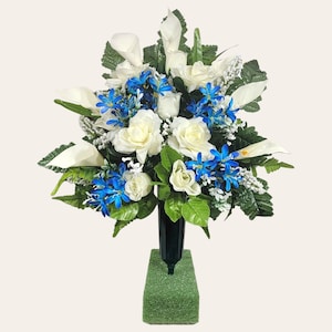 This cemetery cone has grave flowers including Cream Calla Lily and Roses with Blue Filler. It is a perfect funeral or memorial decoration.