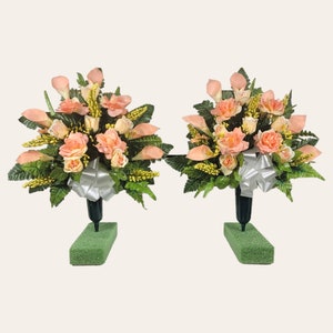 This cemetery cone pair has grave flowers including Peach Calla Lily and Roses. It is a perfect funeral or memorial decoration.