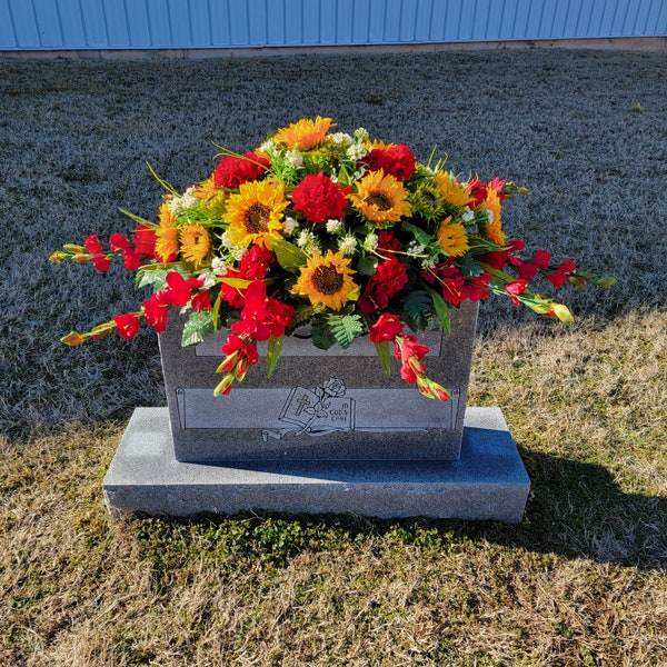 Sunflower Headstone Saddle with geranium grave flowers for cemetery memorial decoration.