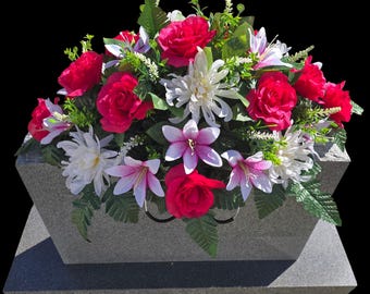 Spring Headstone Saddle with Pink Roses, Lilies, Cream Mums, and Greenery. Pink flowers for cemetery spring memorial decoration.