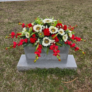 Sunflower Headstone Saddle with geranium grave flowers for cemetery memorial decoration.