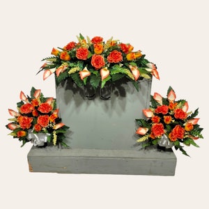 This headstone saddle and cemetery cone set has silk grave flowers including Orange Calla Lilies and Roses.