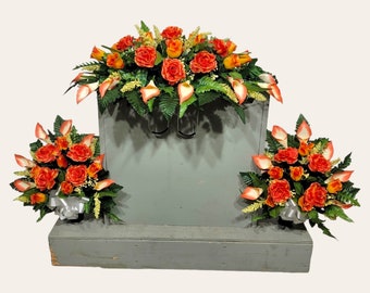 This headstone saddle and cemetery cone set has silk grave flowers including Orange Calla Lilies and Roses.