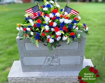 This Headstone Saddle has grave flowers including Red, White, & Blue Mini Mums. It is a perfect Patriotic funeral or cemetery decoration.