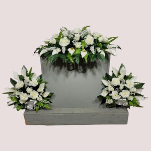 This headstone saddle and cemetery cone set has silk grave flowers including Cream Calla Lilies and Roses.