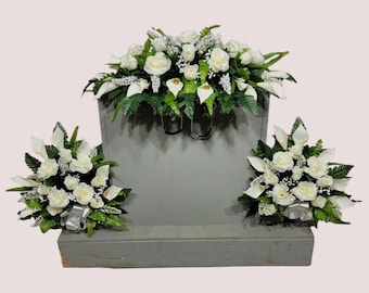 This headstone saddle and cemetery cone set has silk grave flowers including Cream Calla Lilies and Roses.