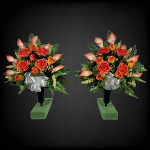 This cemetery cone pair has grave flowers including orange Calla Lily and Roses. It is a perfect fall memorial decoration.