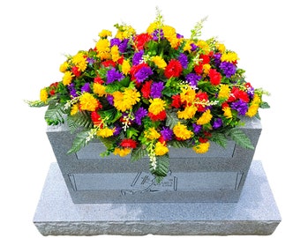 This Headstone Saddle has grave flowers including Multi-Colored Mini Mums. It is a perfect funeral or cemetery decoration.