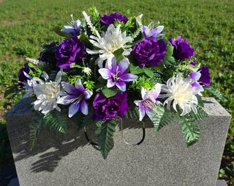 Spring Headstone Saddle with Purple Roses, Lilies, Cream Mums, and Greenery. Purple flowers for cemetery spring memorial decoration.