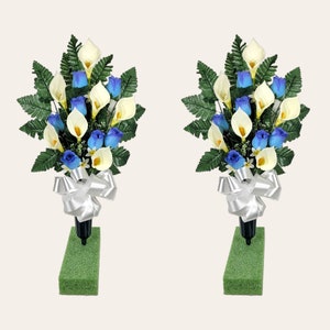 This cemetery cone pair has grave flowers including Baby Blue Rosebuds and Cream Calla Lillies. It is 2 funeral or memorial decorations.