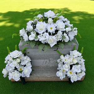 This headstone saddle and cemetary cone set has cream roses, white gerbera daisies, hydrangeas, bells of Ireland and more!