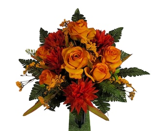 This cemetery cone has grave flowers including mums and 2 tone orange Roses.  It's a funeral summer/fall memorial decoration.