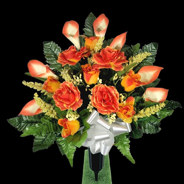 This cemetery cone has grave flowers including orange calla lilies and roses. It is a perfect funeral or cemetery memorial decoration.