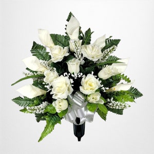 This cemetery cone has grave flowers including cream Calla Lily and Roses. It is a perfect summer memorial decoration.