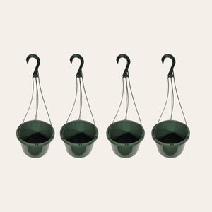 May include: Set of four dark green plastic hanging planters with black hooks. Each planter has a wire hanging system.