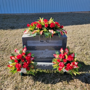 This headstone saddle and memorial cone set has silk grave flowers including Red Calla Lilies and Roses for cemetery.